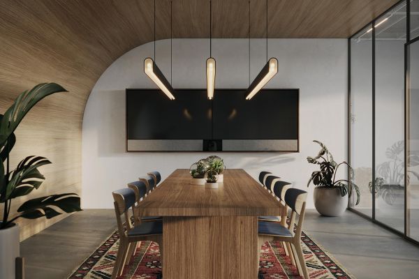 A sophisticated meeting room with a wooden ceiling, pendant lighting, and a large screen, set within a modern office environment.