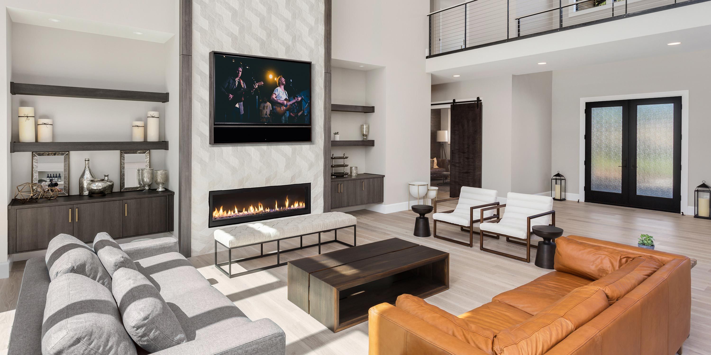 A spacious, open-concept living area with multiple seating options, a modern fireplace, and a large TV, ideal for family gatherings.