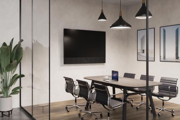 A sleek conference room with glass walls, black chairs, and a large screen, set against a minimalist decor.