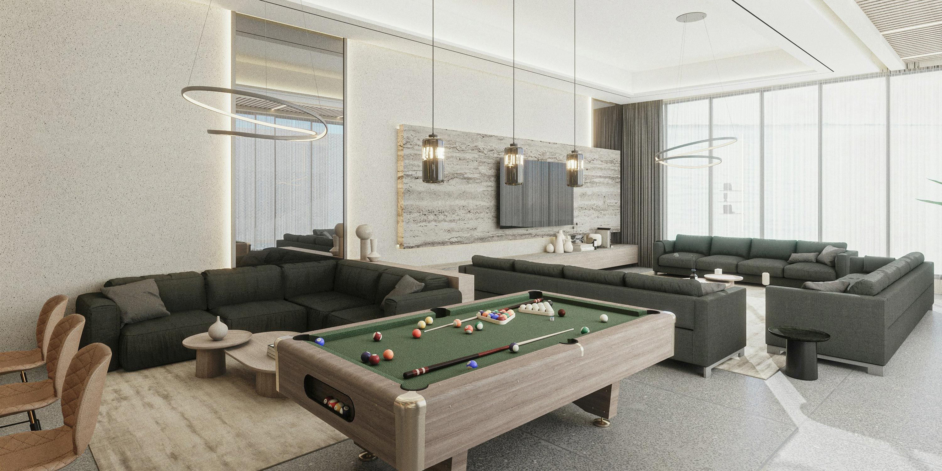 A stylish game room with modern seating, a pool table, and a large wall-mounted TV, creating a relaxing entertainment space.