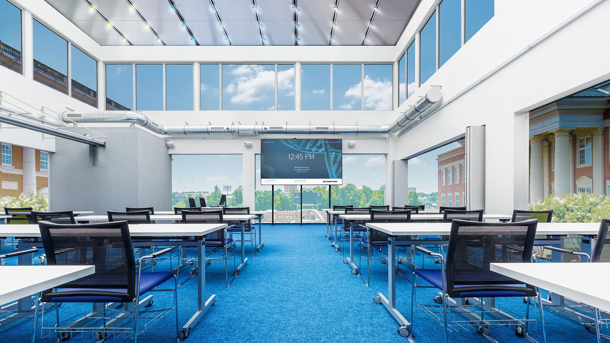 Bright conference room with Crestron daylight harvesting solutions optimizing natural light.